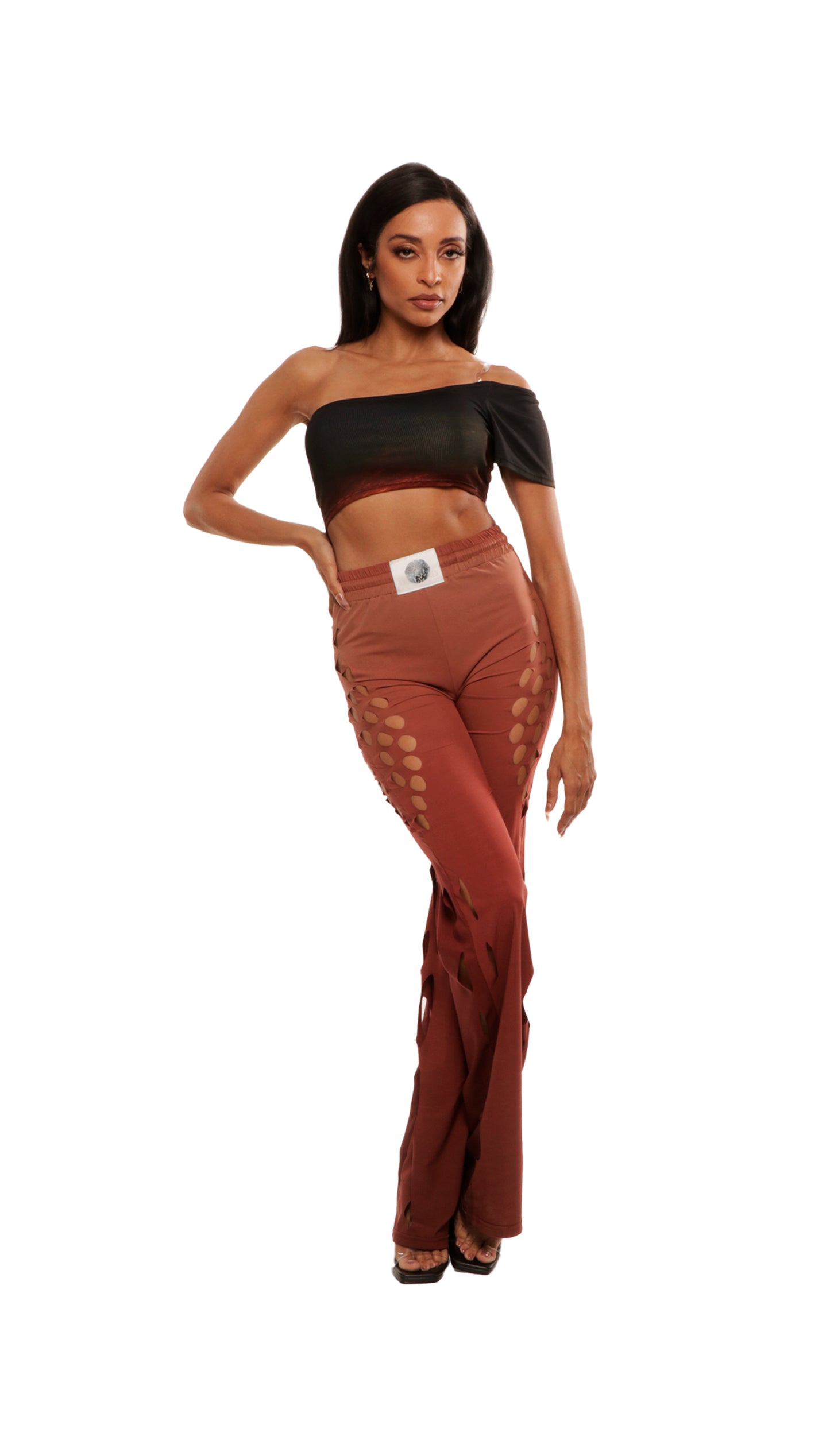 Woman who looks like Beyoncé or Aaliyah wears gradient brown toned bottoms or pants with cutout details on the sides, front view