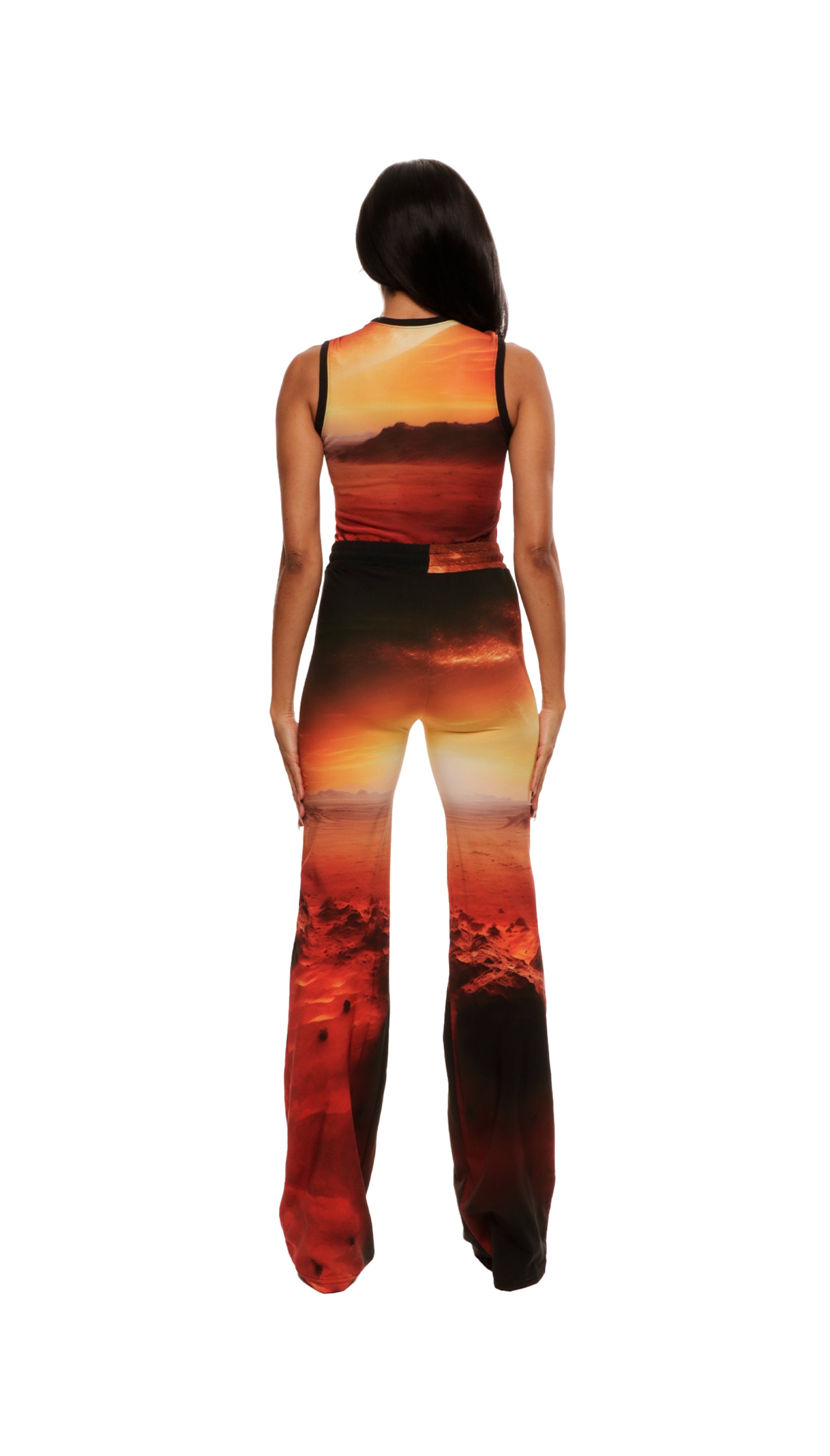 Woman who looks like Beyoncé or Aaliyah wears cosmic Mars sunset printed wide leg pant, back view 