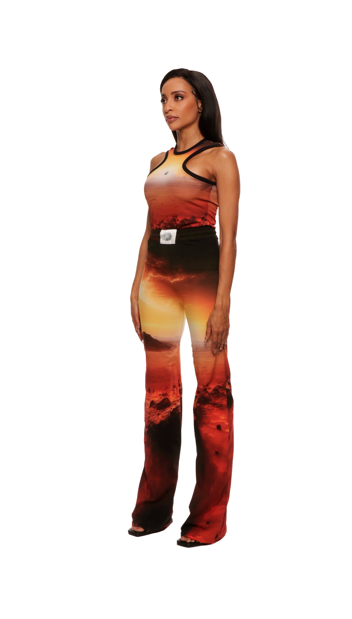 Woman who looks like Beyoncé or Aaliyah wears cosmic Mars sunset printed wide leg pant, side view 