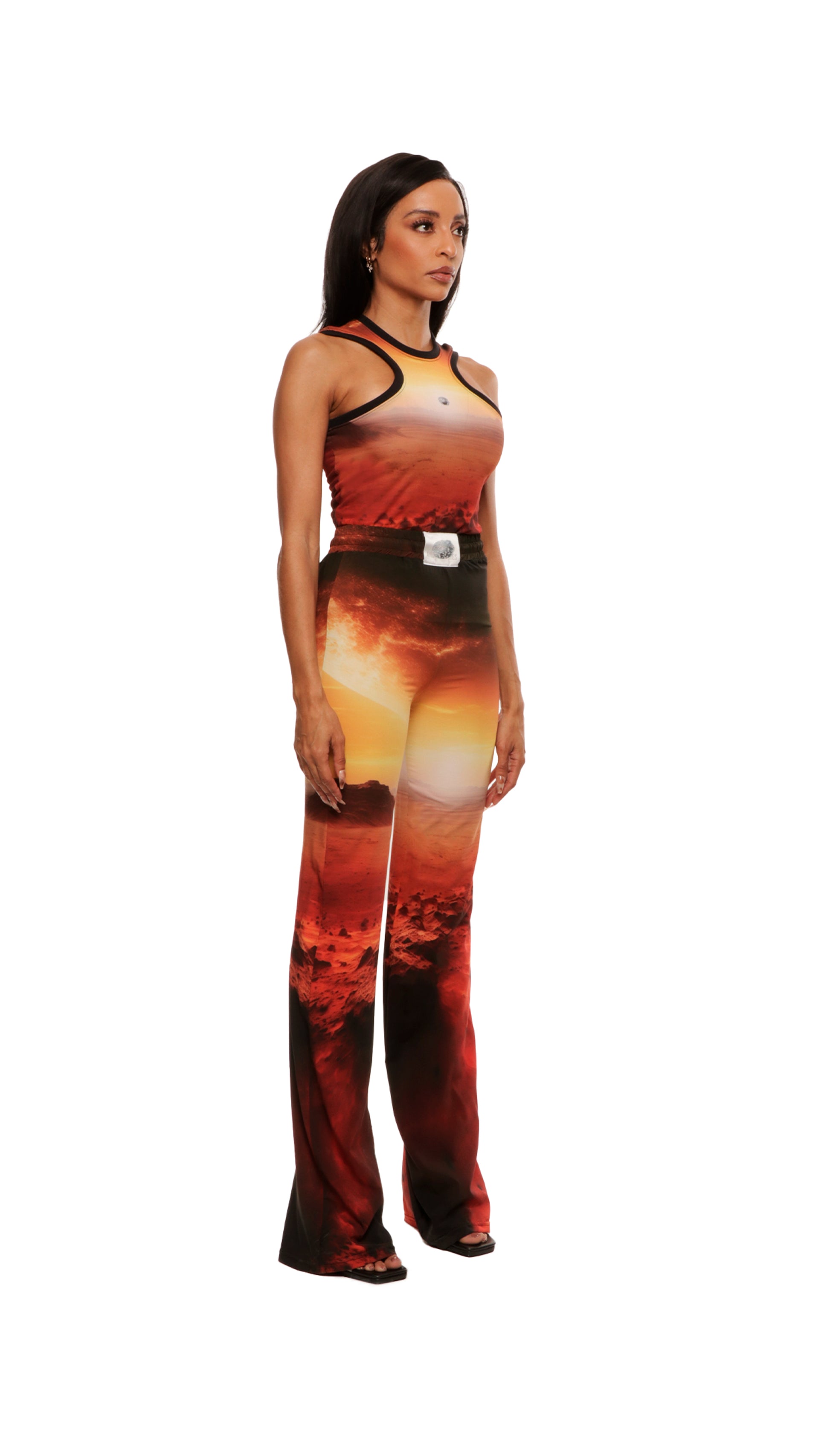 Woman who looks like Beyoncé or Aaliyah wears cosmic Mars sunset printed wide leg pant, side view 