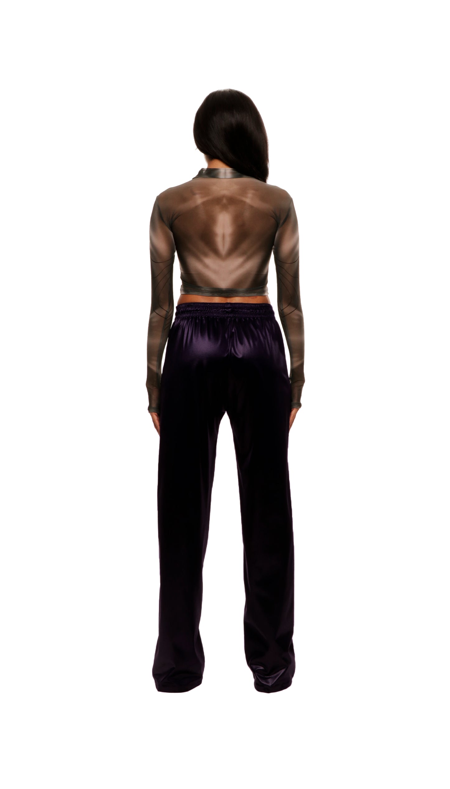 Woman who looks like Beyoncé or Aaliyah wears berry colored stretch smooth nylon pants with open detail front, paired with a grey stretch mesh long sleeve shirt top. Back view.